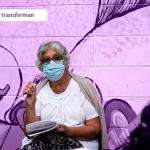 mujer de tapabocas sosteniendo un microfonono destacada con filtro violeta en el fondo y ella en colores