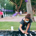 mujer pintando la pancarta